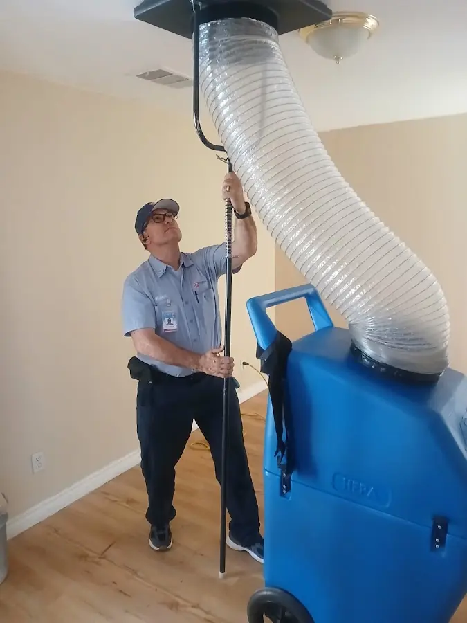 Furnace Tune-Up technician using HEPA equipment in Lafayette